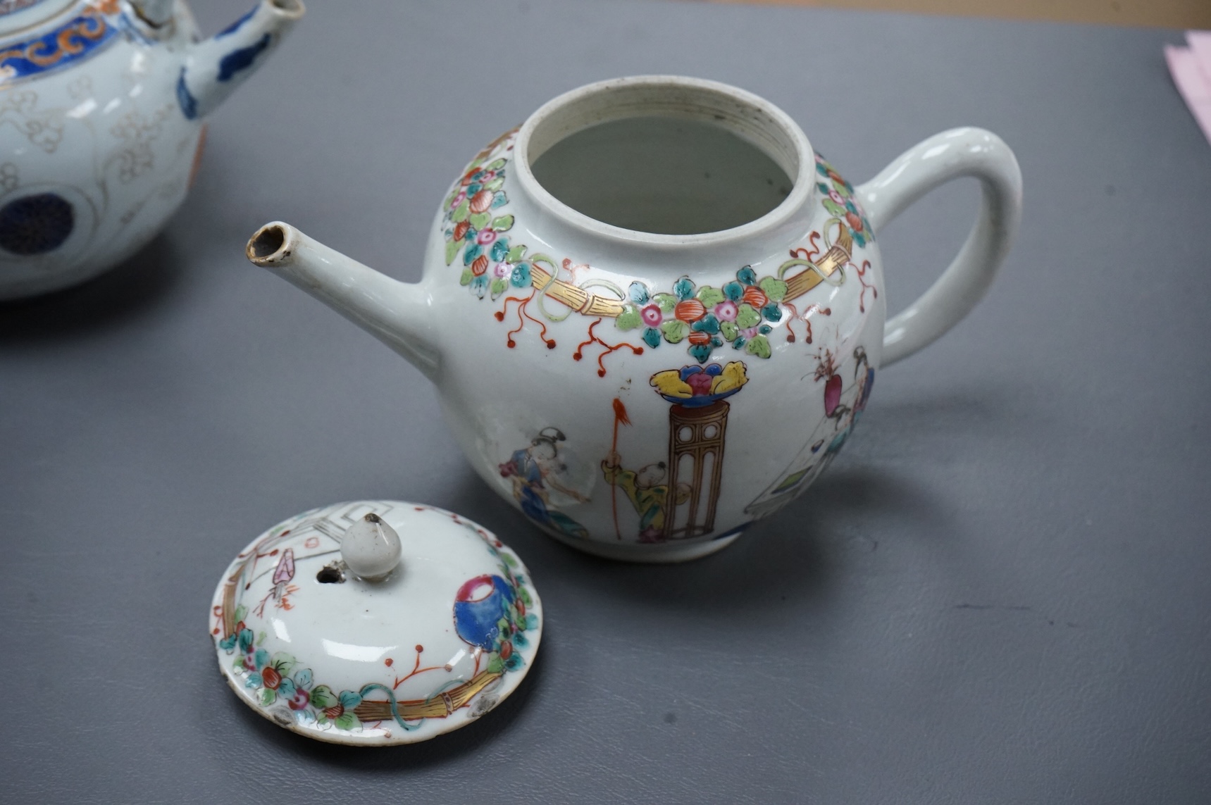 A Chinese famille rose ‘boys and ladies’ teapot, Qianlong period and a Japanese Arita sake pot or ewer, early 18th century, tallest 16cm high.